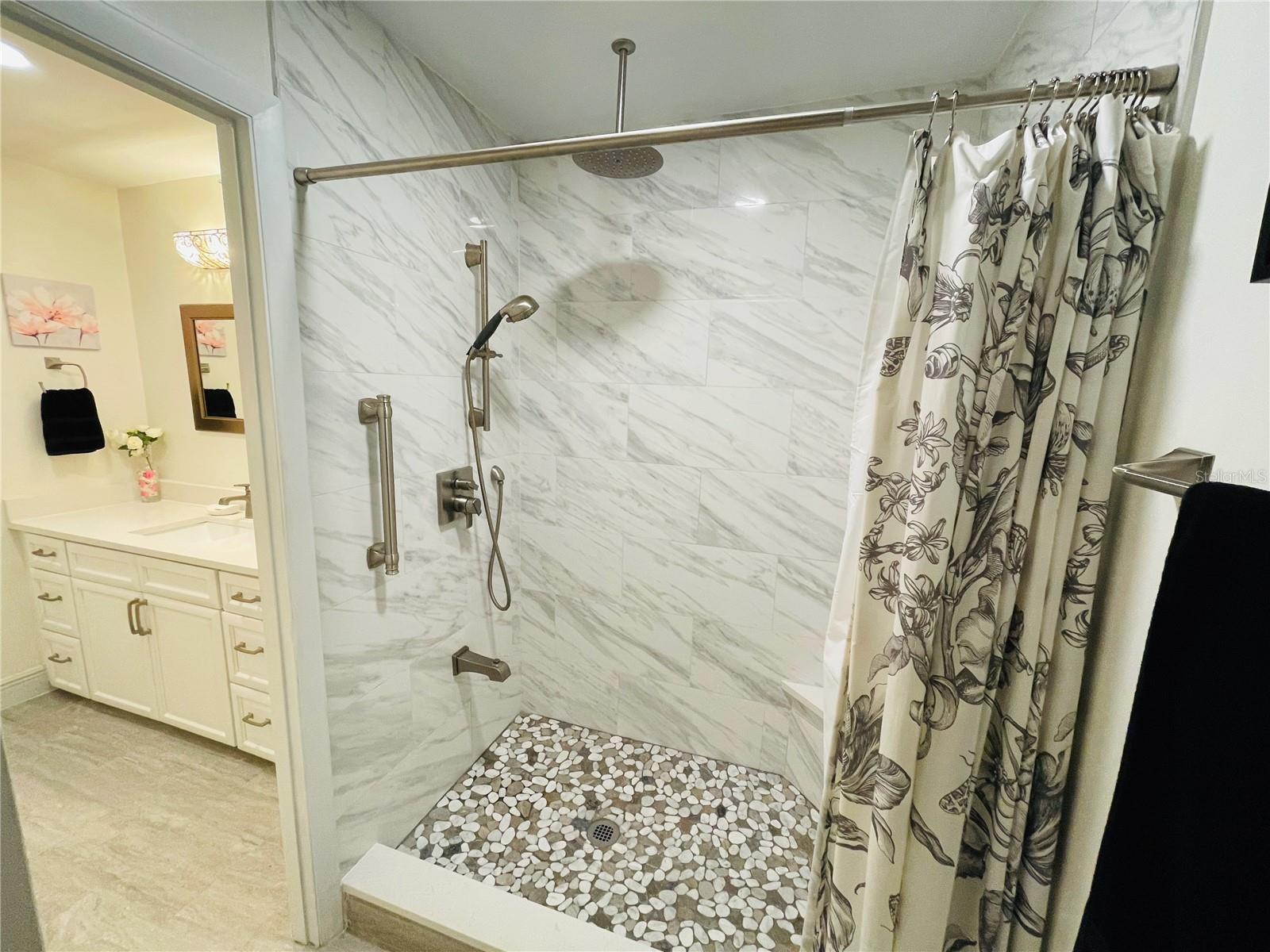 Rainfall shower and river pebble tile floor