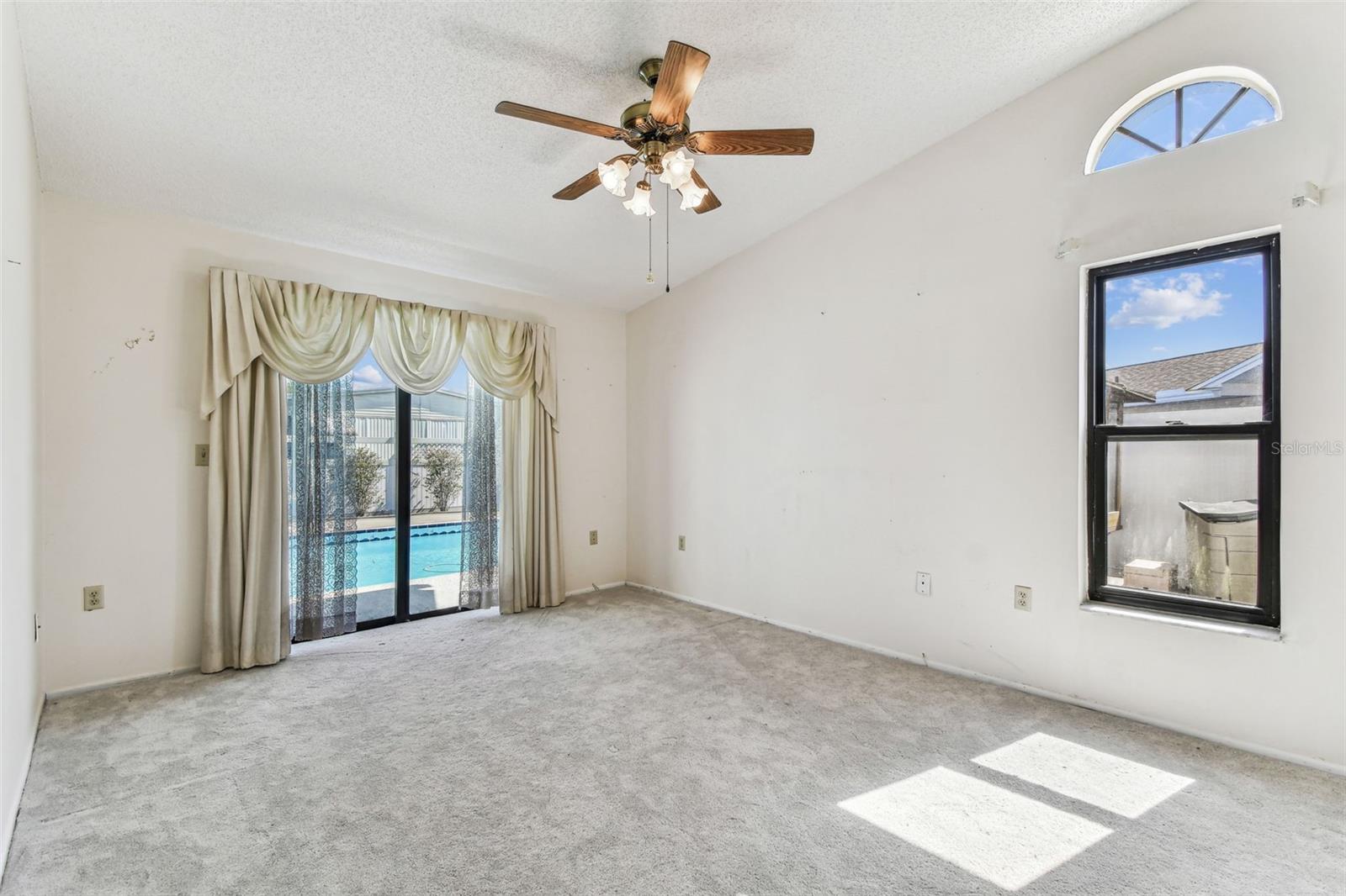 Primary bedroom with pool view