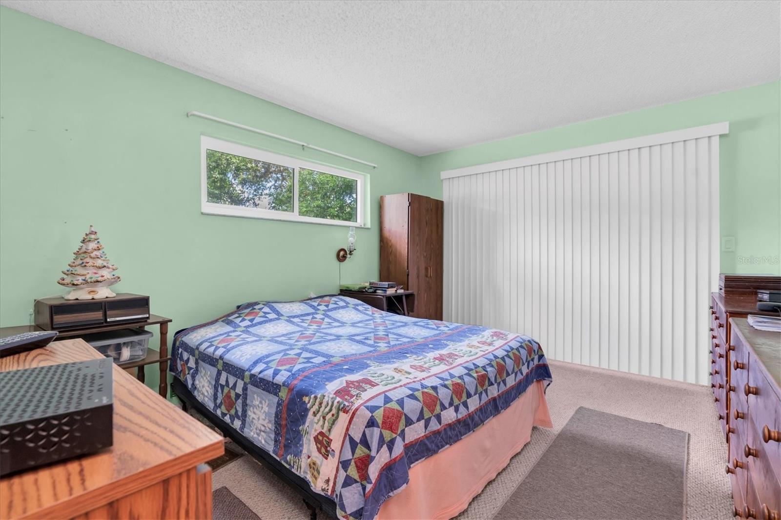 Primary Suite with patio doors leading out to the Florida room