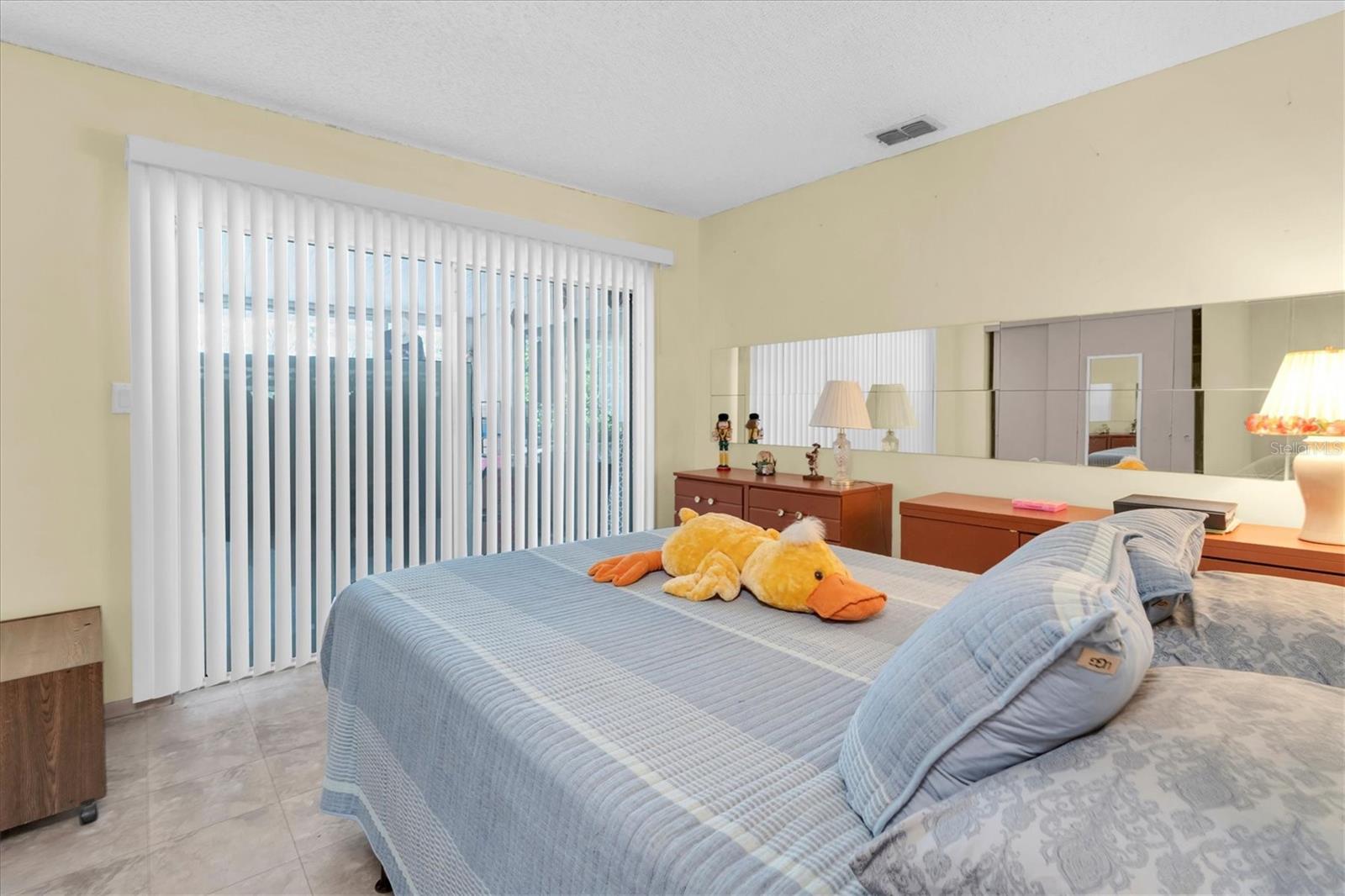 Bedroom 2 with patio door leading to Florida room