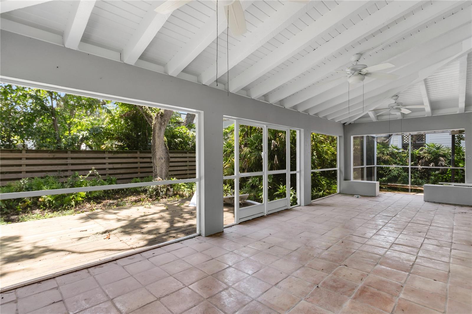 The screened in lanai runs the entire width of the home.