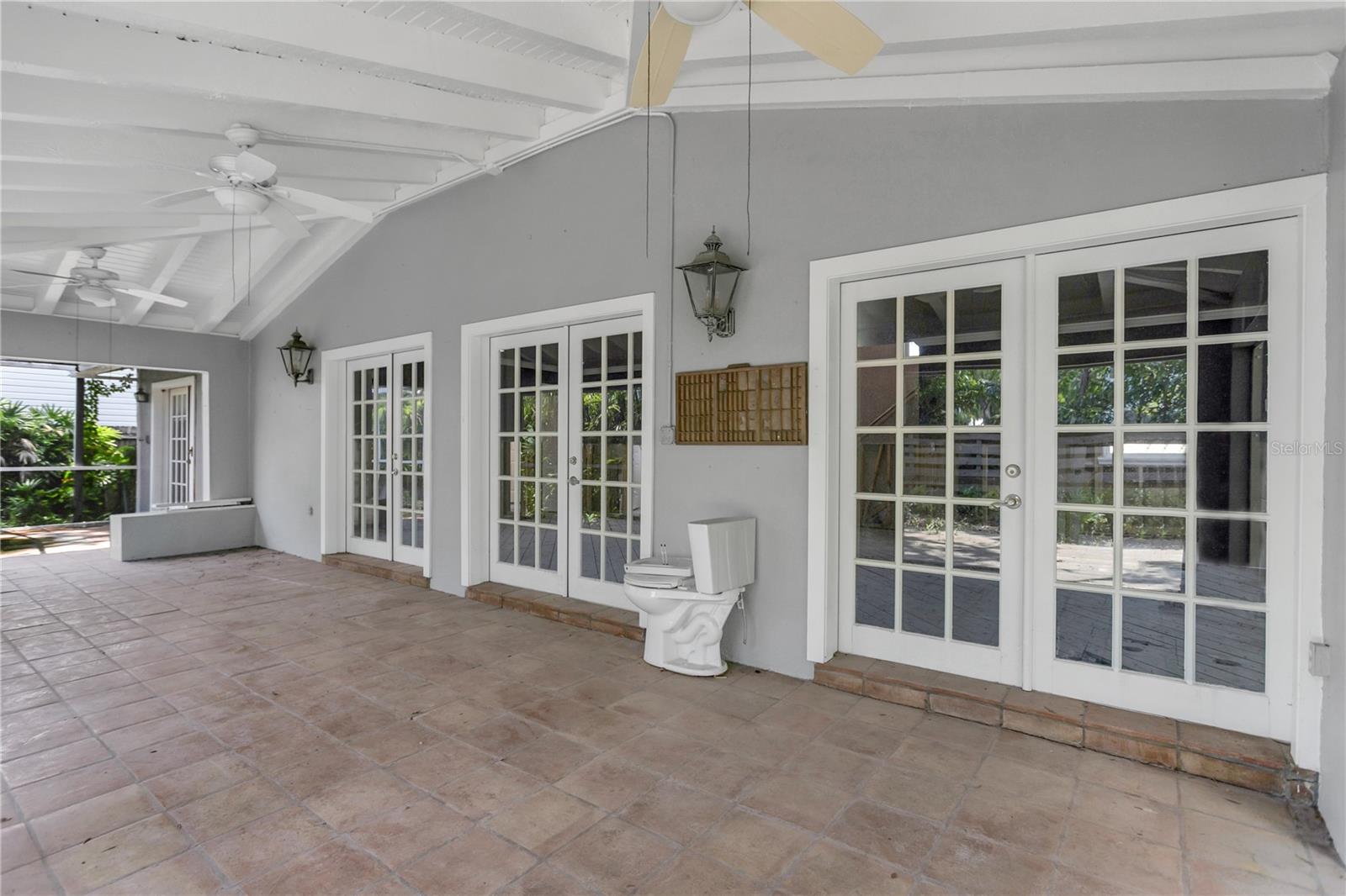 This screened in space is a natural extension of the home. Just open the French doors and let the outside in.