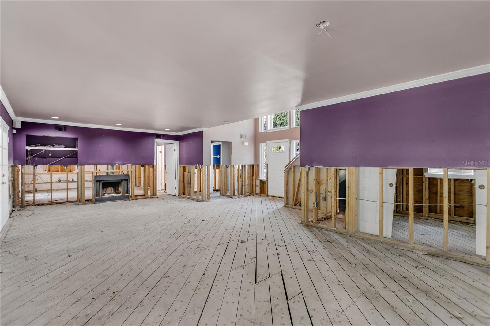 The light filled living room features a wood burning fireplace.