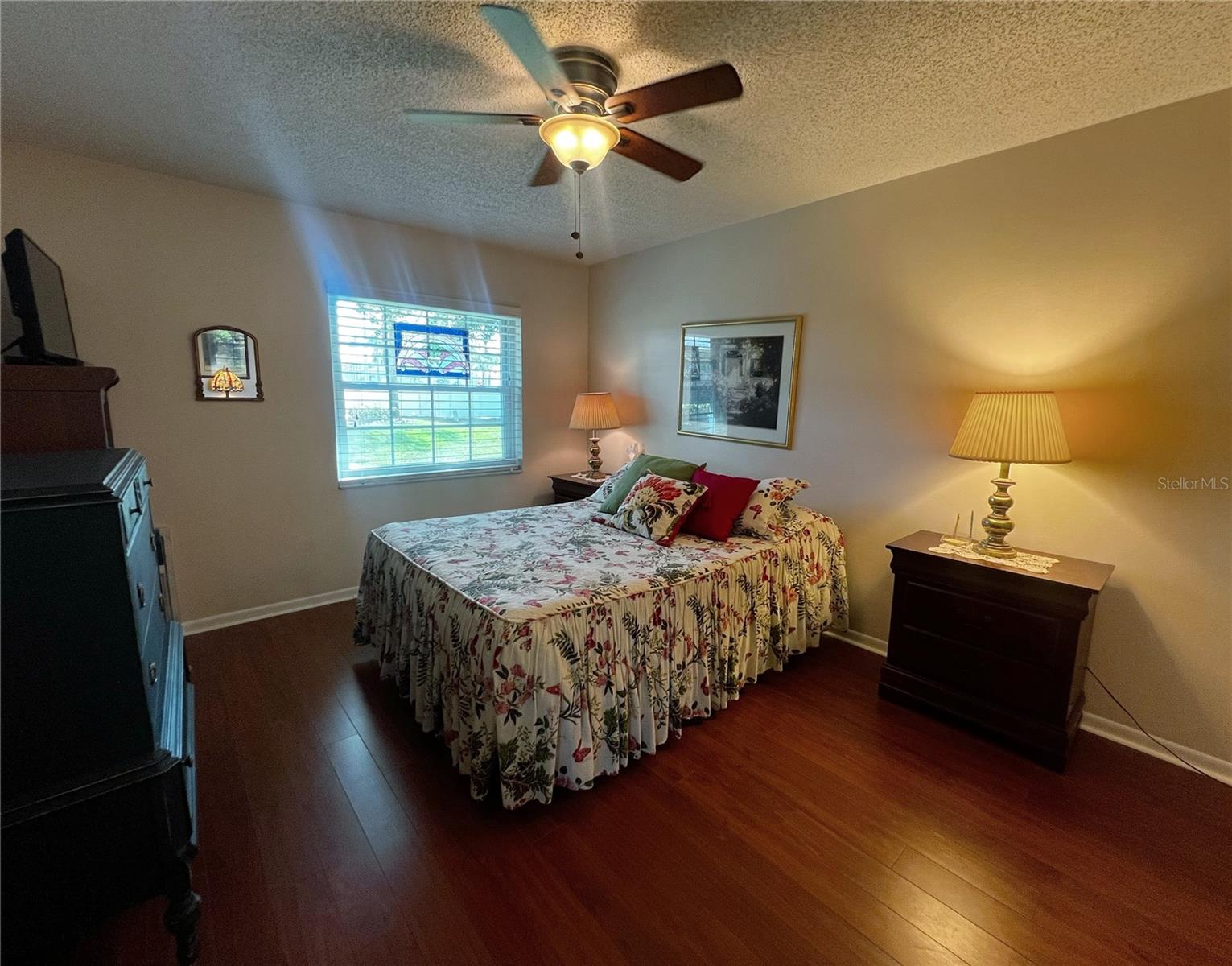 Primary suite with a private attached bathroom and a window.