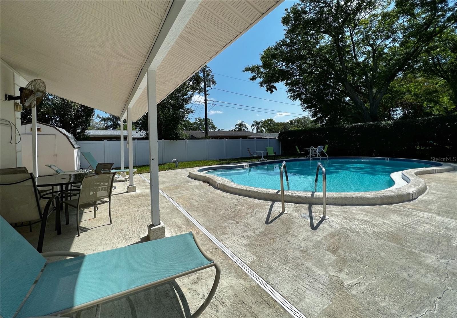 Heated pool with sitting area at the community.