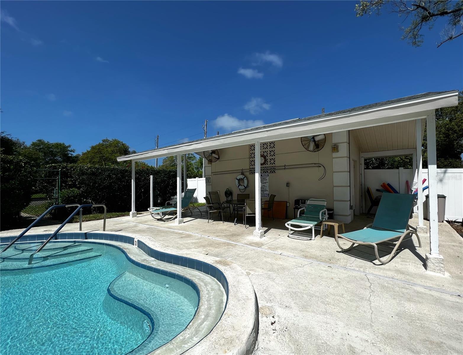Pool with bathrooms and a shaded sitting area for your use at the complex.