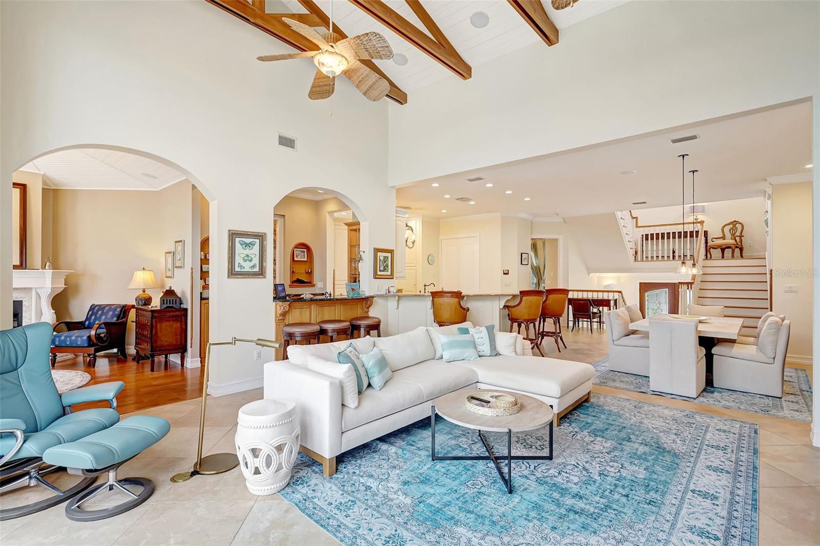 The Open Floor Plan Centers Around The Living Room With Beautiful High Wood-Beamed Ceilings.