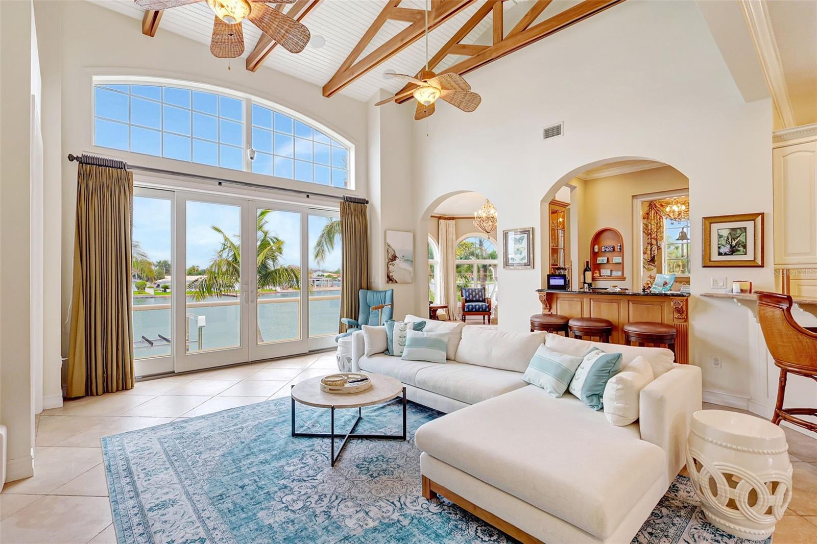 This Home’s Entertainment Center Boasts A Wet Bar With Granite Counters, Dual Wine Chillers & Captivating Water Views!