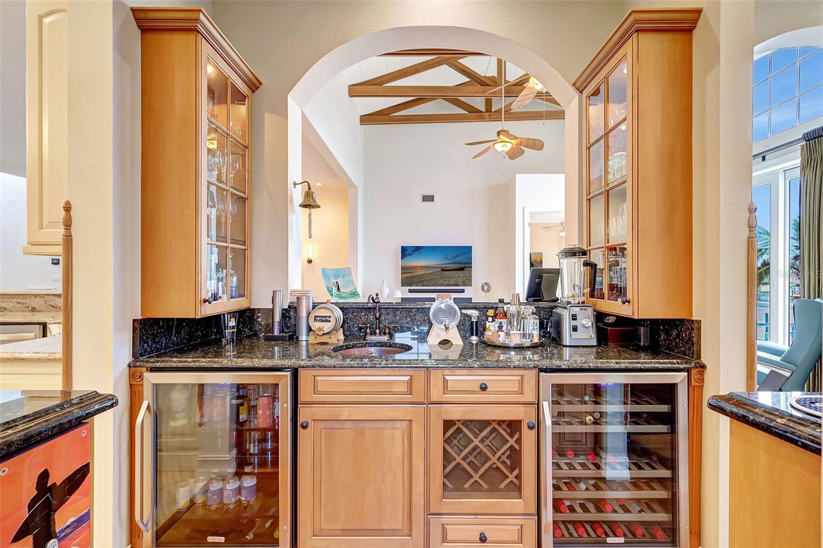 The Entertainment Room, Adjacent To The Kitchen & Gathering Room, Features Wood Cabinets, A Sink & 2 Wine Chillers.