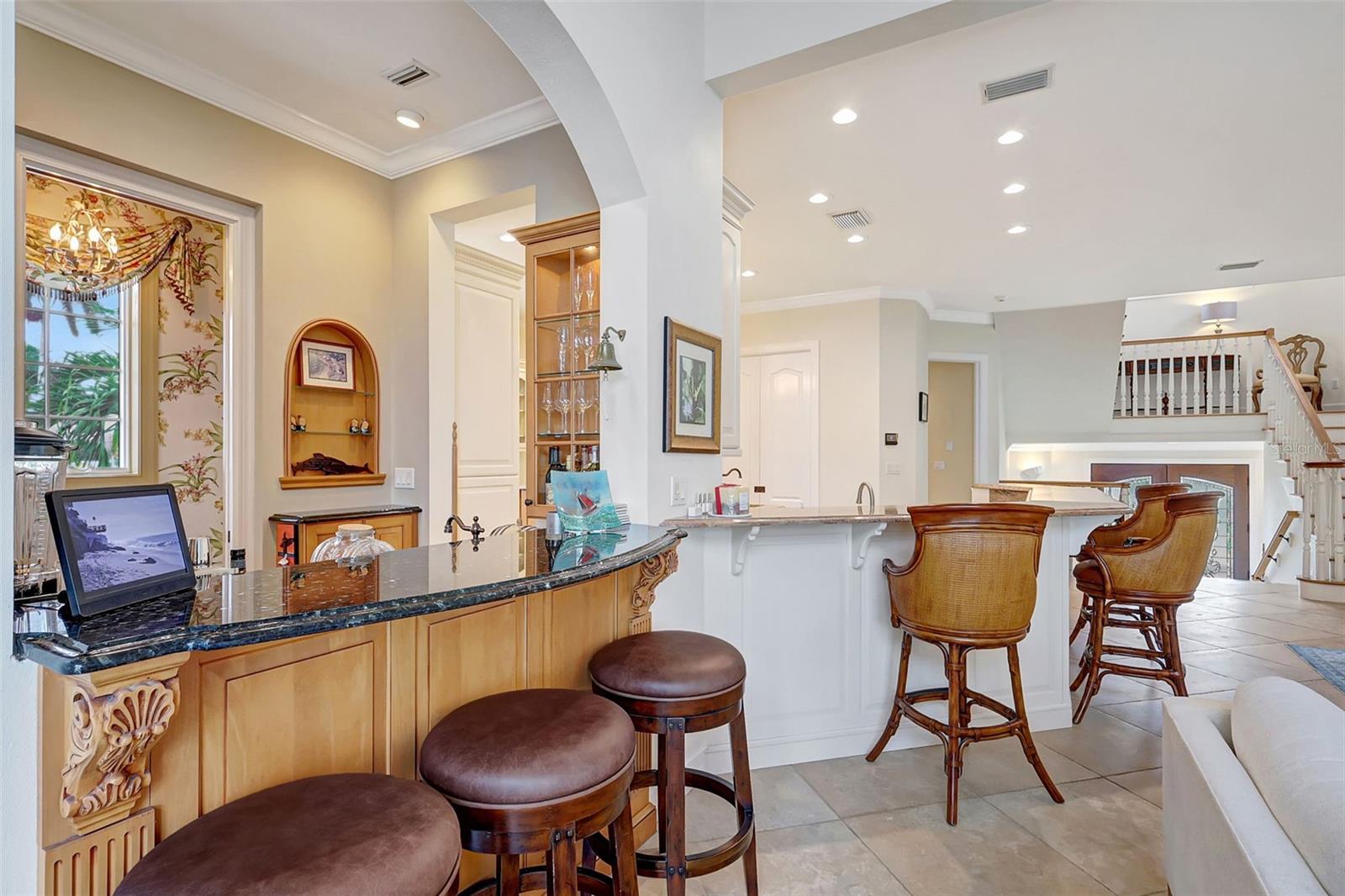The Entertainment Room Features Warm Wood Tones, Granite Counter & Crown Molding.