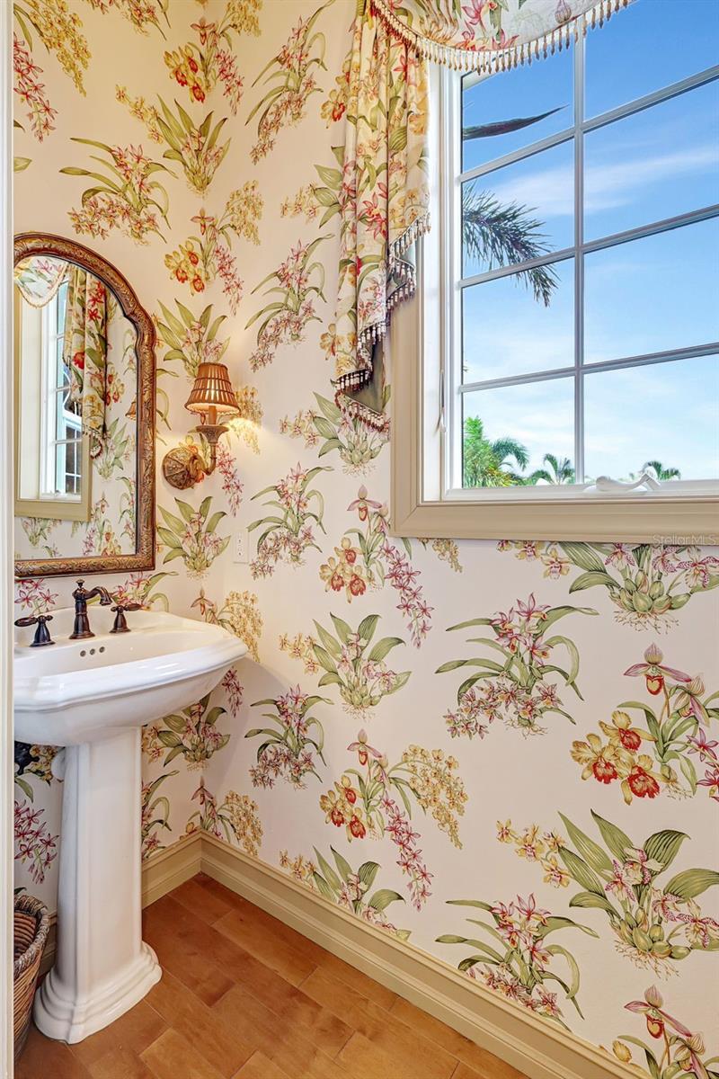 A Guest Half Bathroom Is Conveniently Nestled Near The Entertainment Room.