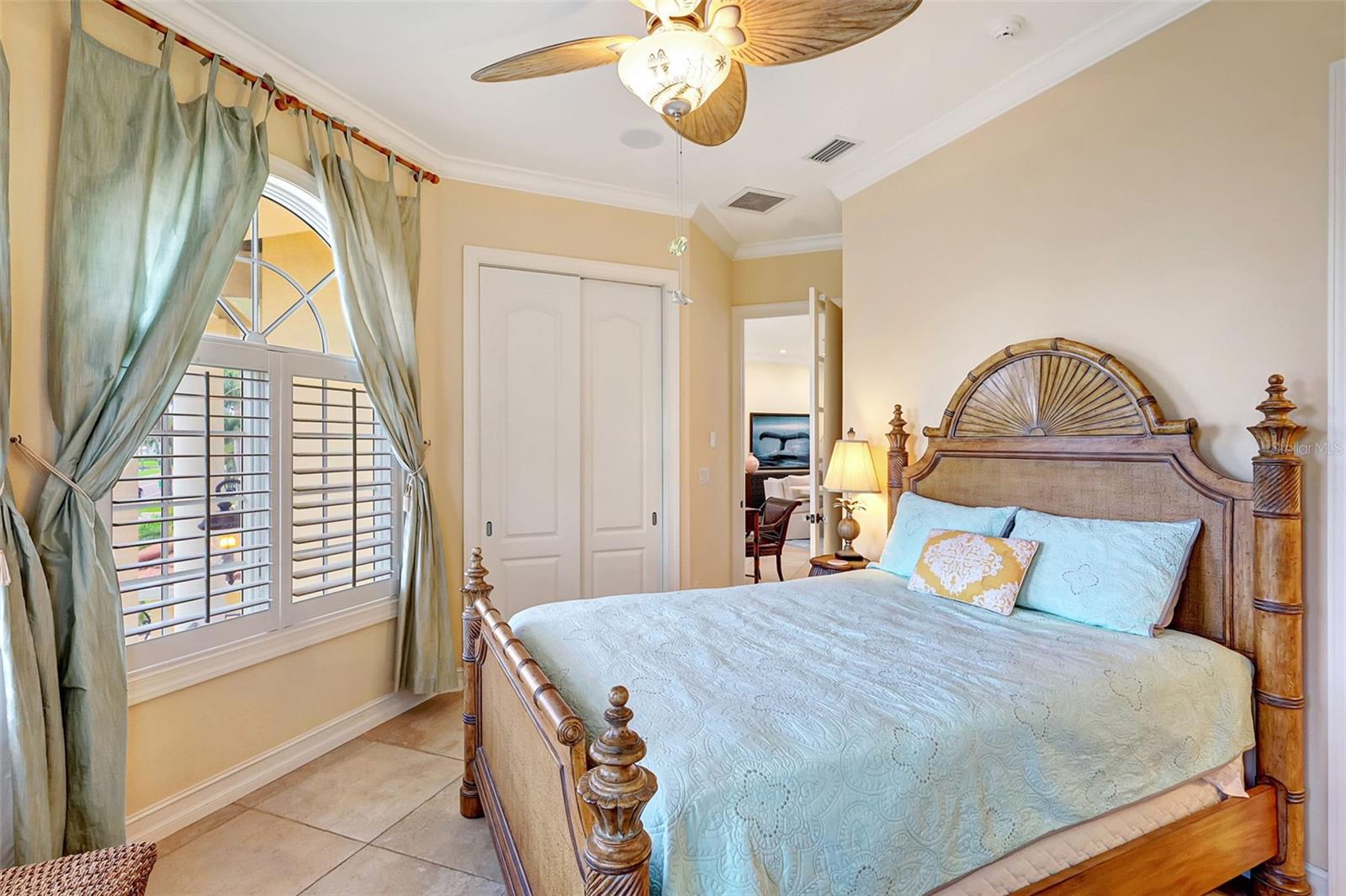 The Second Bedroom Features Tiled Floors, Lovely Crown Molding & Also Has A Private Full Bathroom.