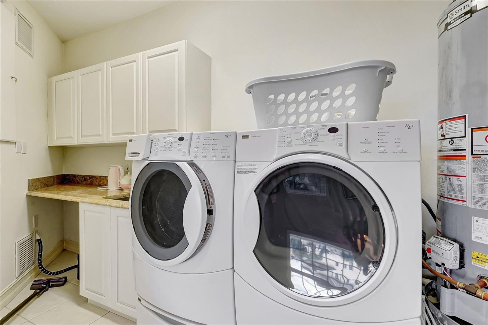 The Laundry Closet Is Spacious With Cabinets, Sink & Granite Counter Top.