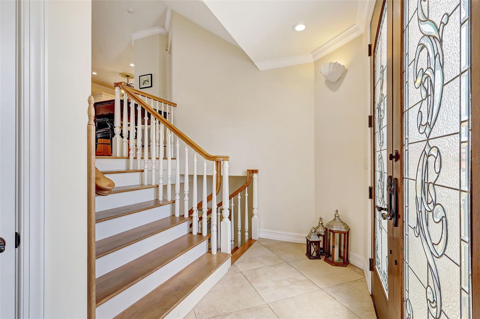 Elegant Double Etched Glass Doors Open To  A Welcoming Foyer.