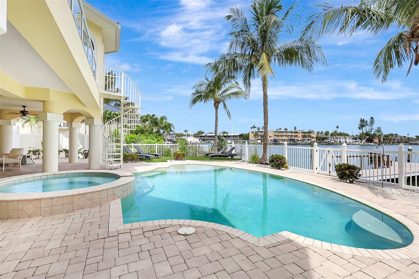 Expansive paver decking surrounds the pool, creating an inviting space for lounging, entertaining, and soaking up the sun with ease.