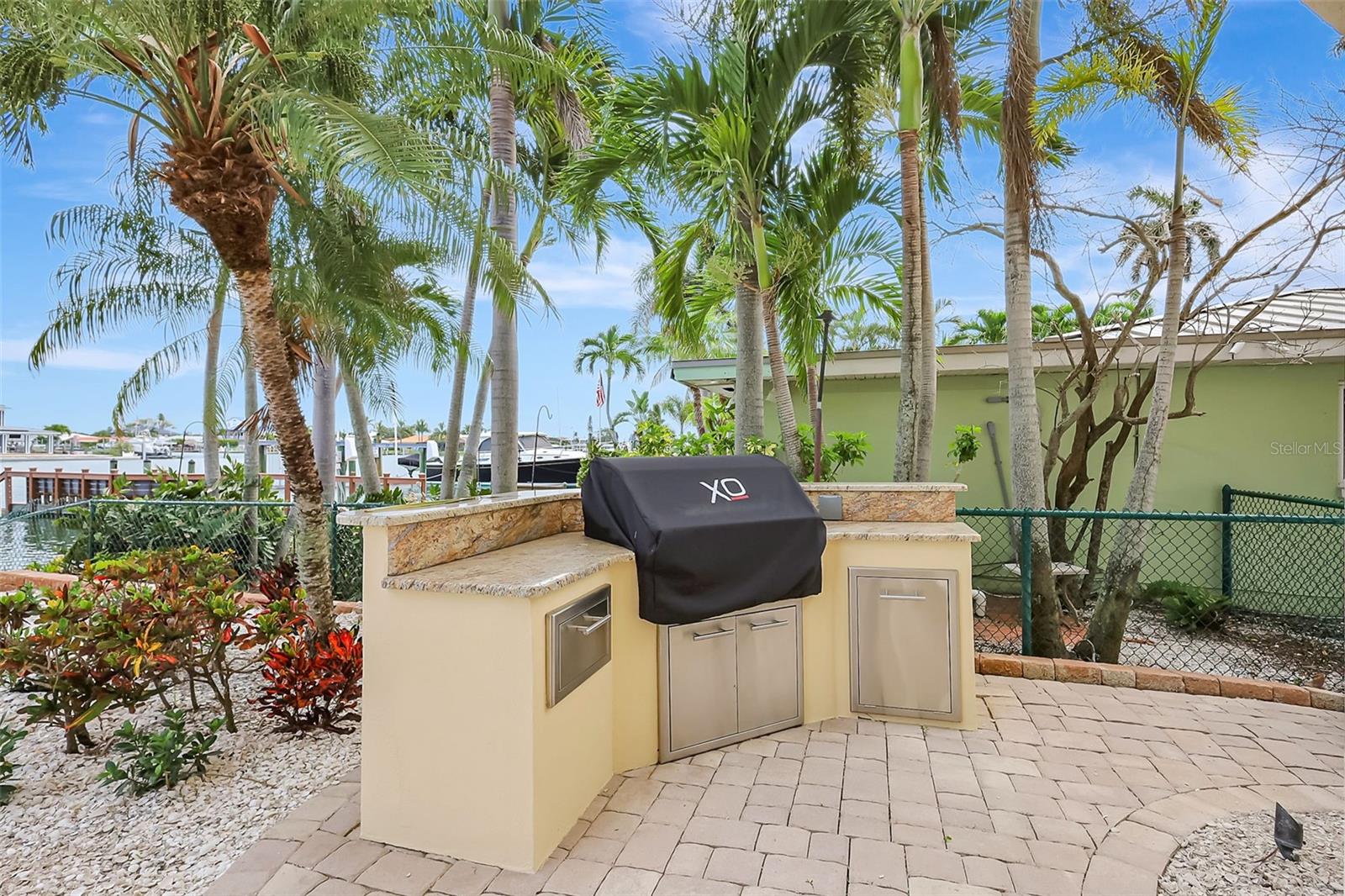 The waterfront yard features a built-in grilling station, perfect for outdoor cooking with a view!