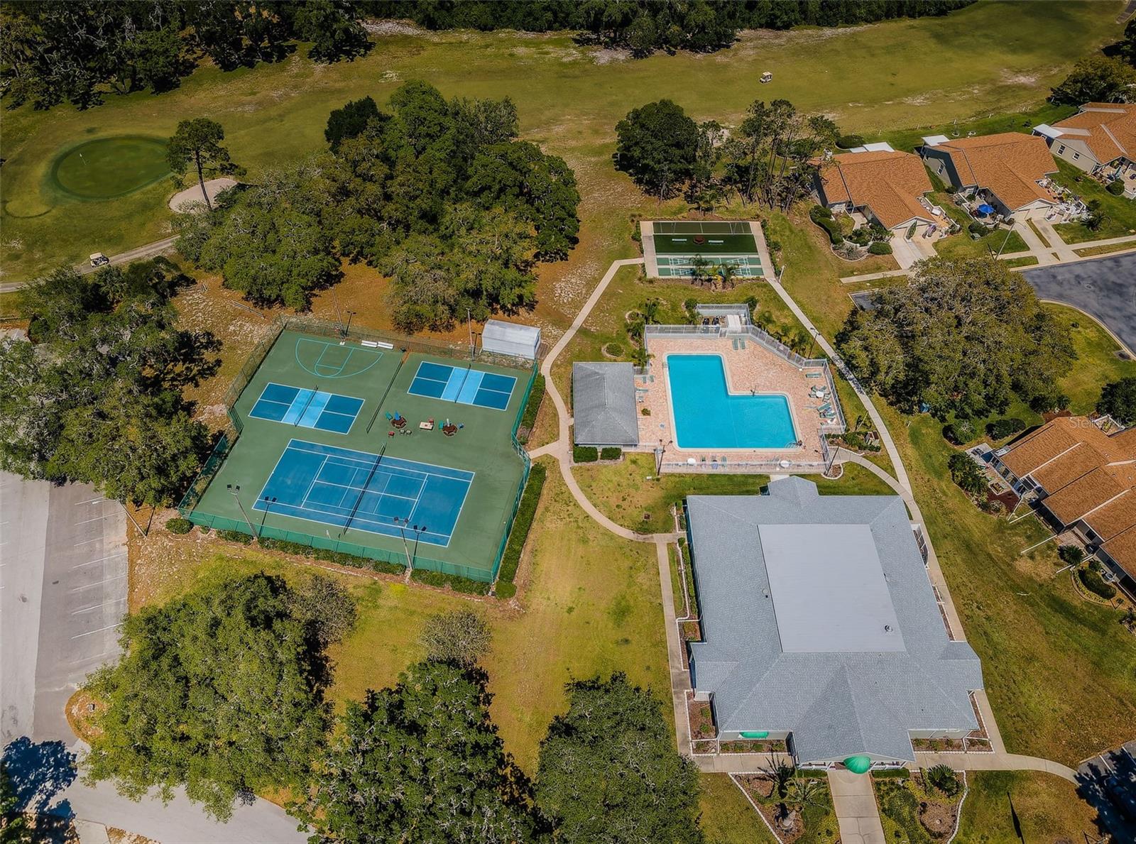 Clubhouse with pool, shuffleboard, tennis, and pickleball