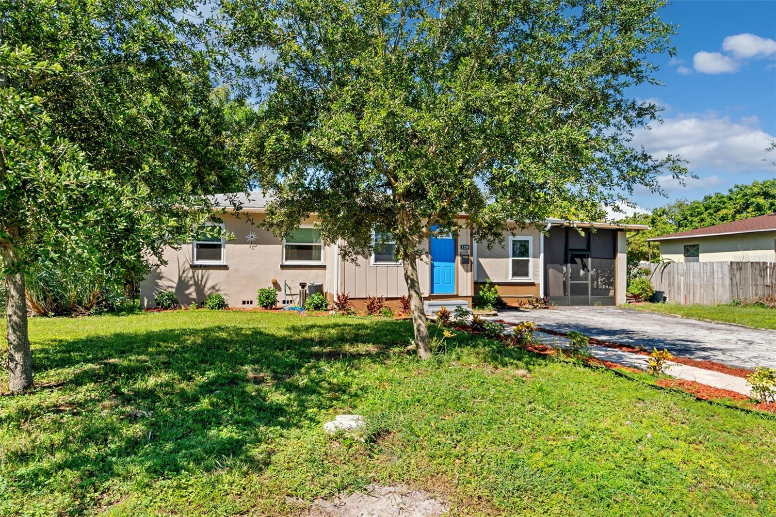 Large front yard with mature landscaping