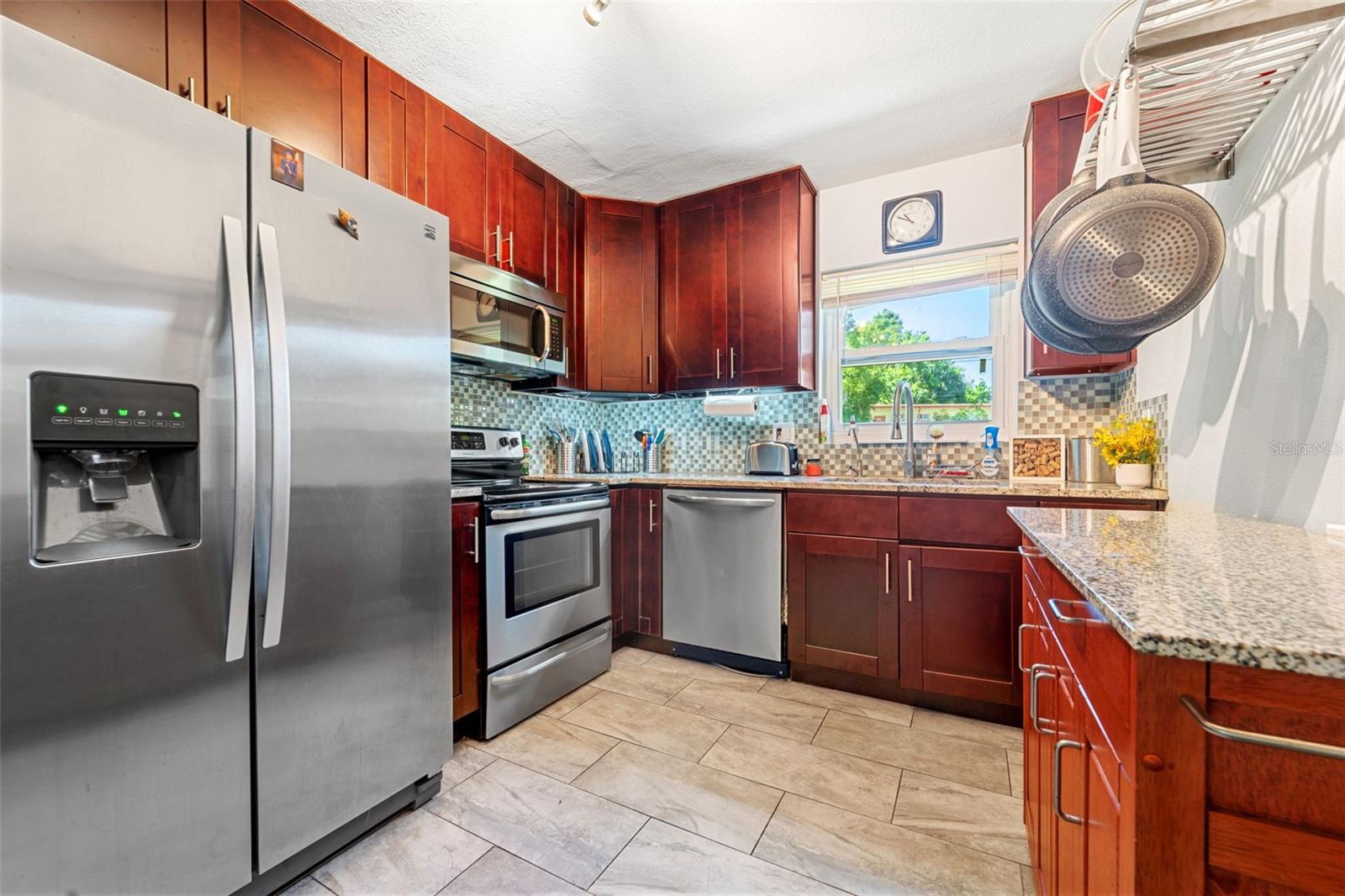 Beautiful Wood cabinets and gorgeous Stainless make this updated kitchen ready for your next meal!