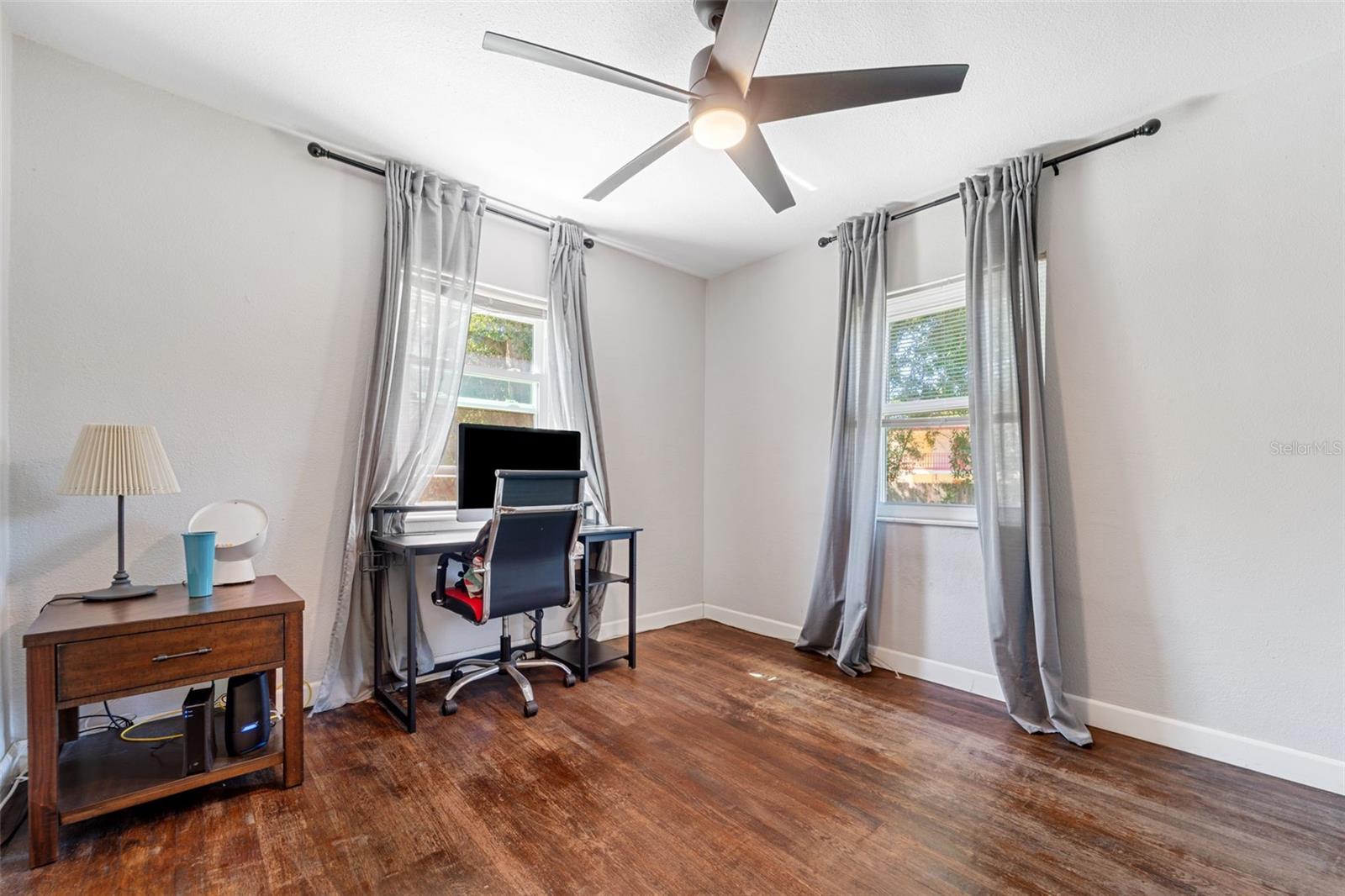 Two huge windows provide great light in this huge bedroom!