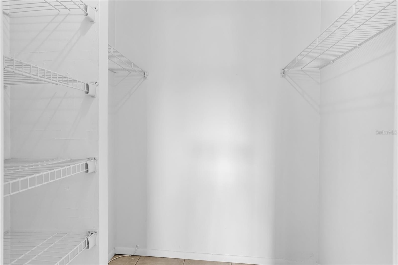 Primary bedroom walk-in closet