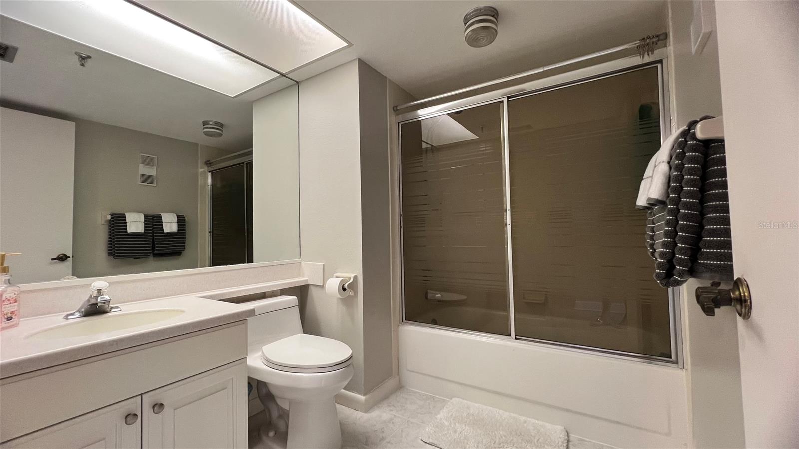 Hallway bathroom with tub