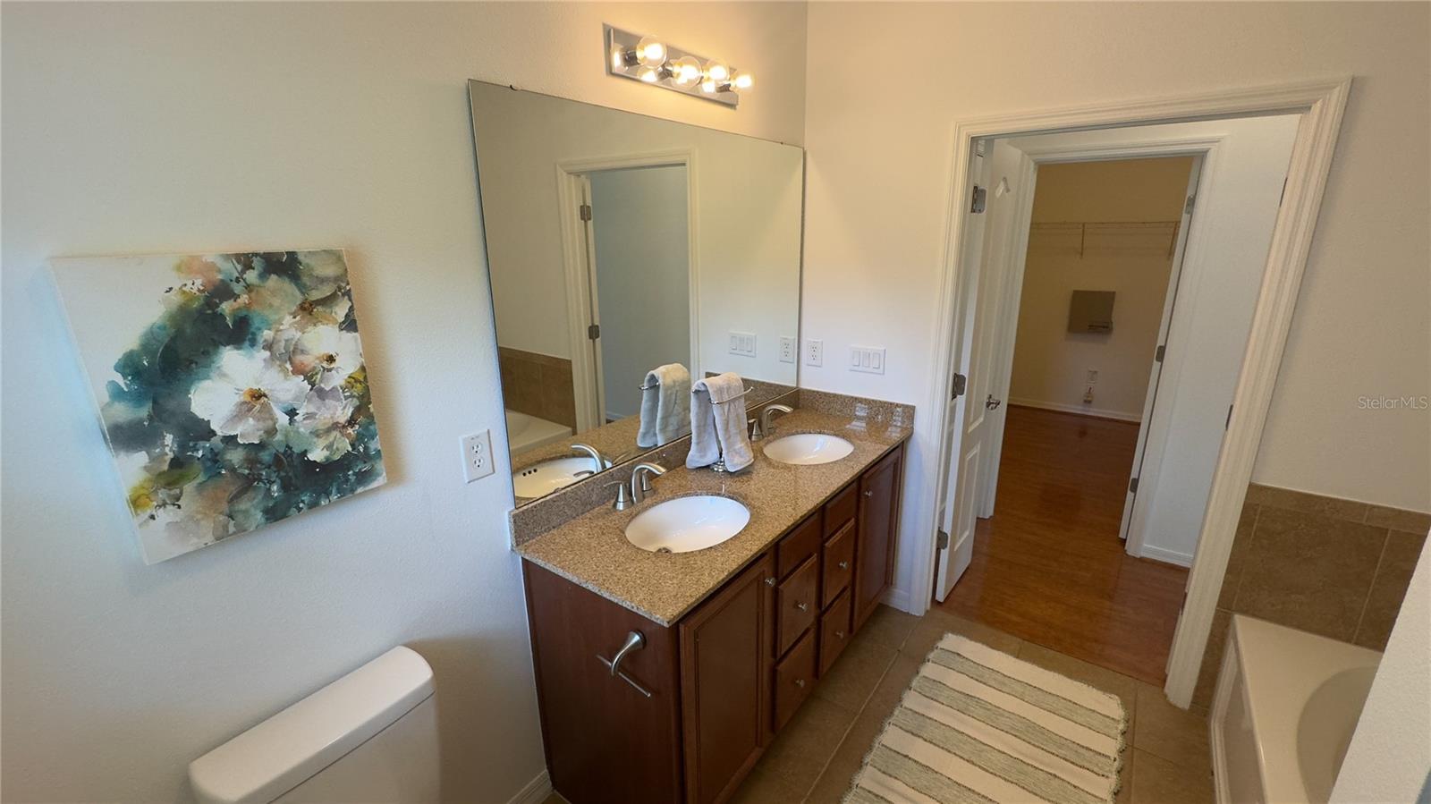 Linen closet outside bathroom door and walk-in closet directly across from master bath.