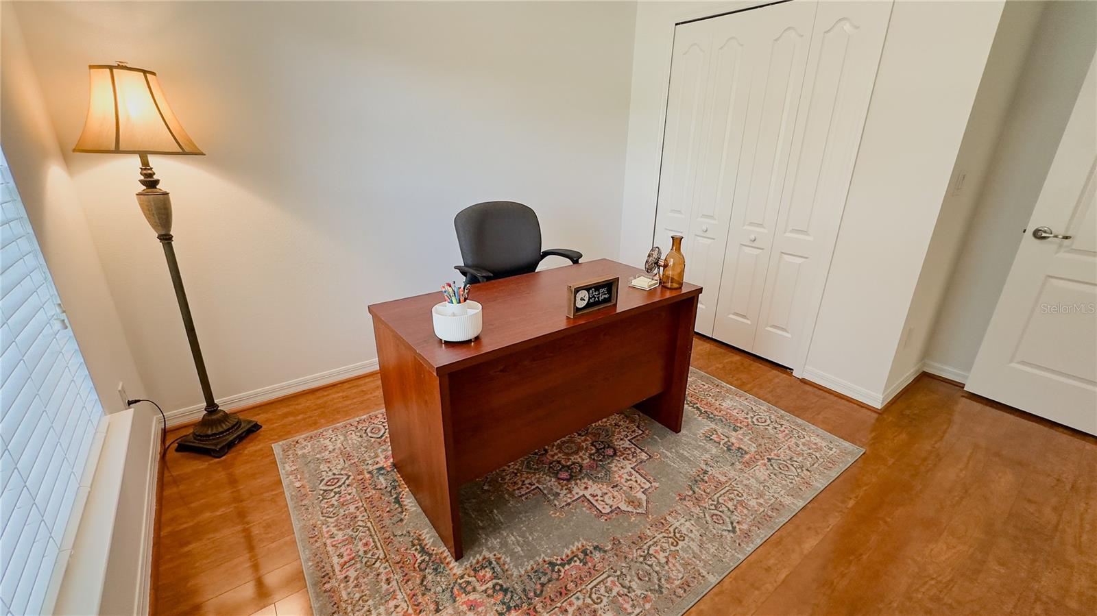 Bedroom 1 staged as a home office. Add bookshelves and a chaise lounge and you have a great library office.
