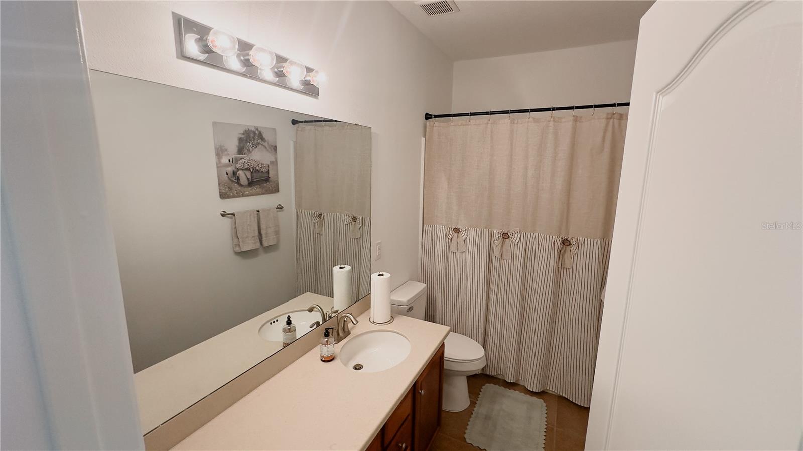 Guest bath with large mirror and vanity