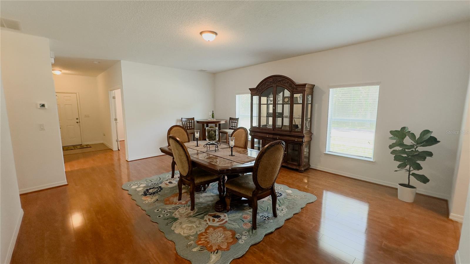 Dining room windows bring in alot of natural light as well as overlook the left side of the house, street and wooded area. Furniture is negotiable.