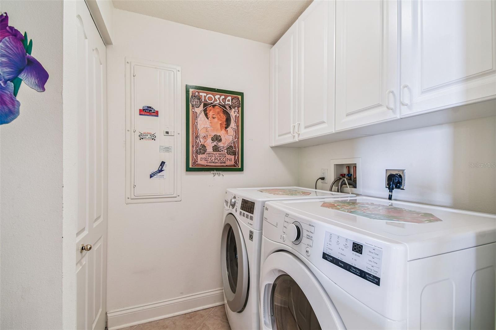 Newer washer and dryer in Laundry Room with with sink and cabinets