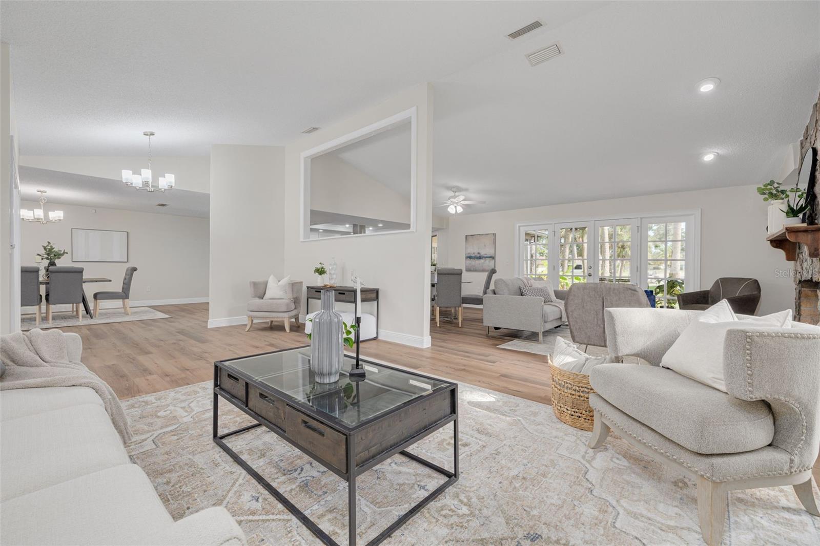 Formal living room adjoins the family room with French doors to the screened lanai!