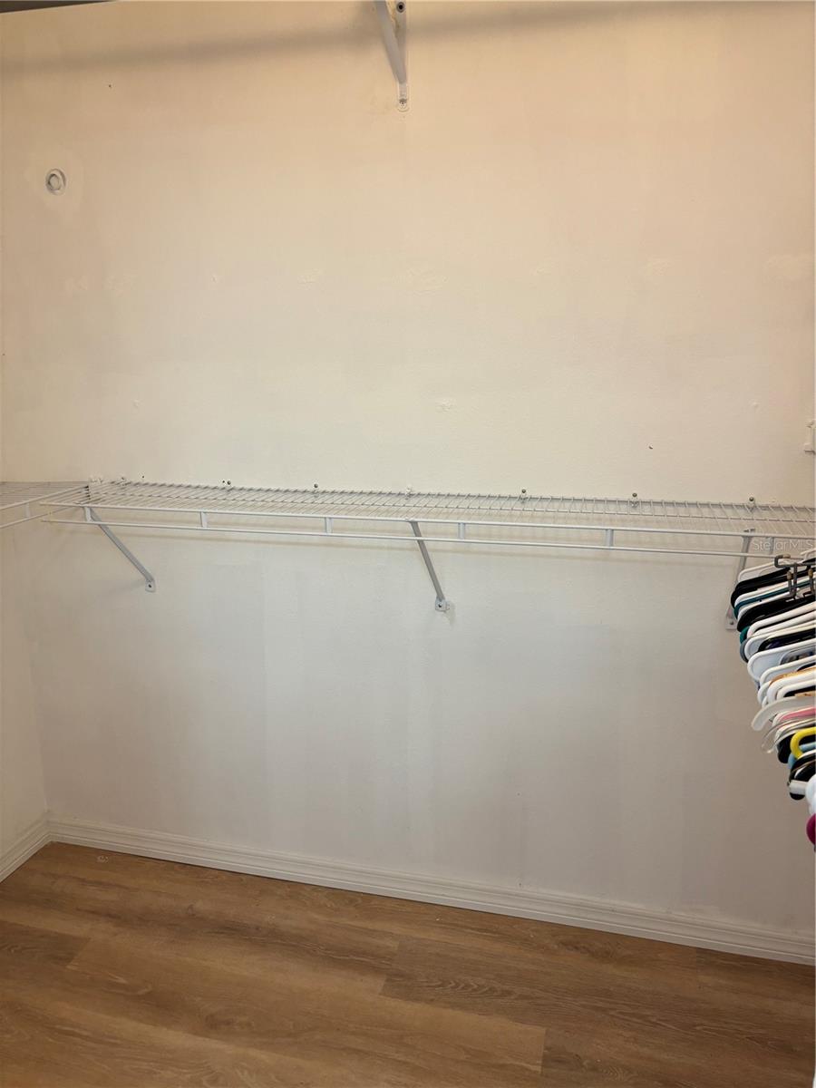 Primary bedroom walk-in closet