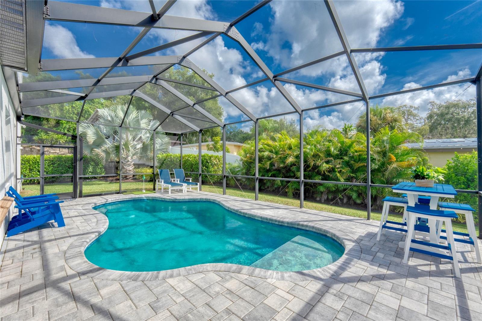 Saltwater pool with paver deck and screened lanai