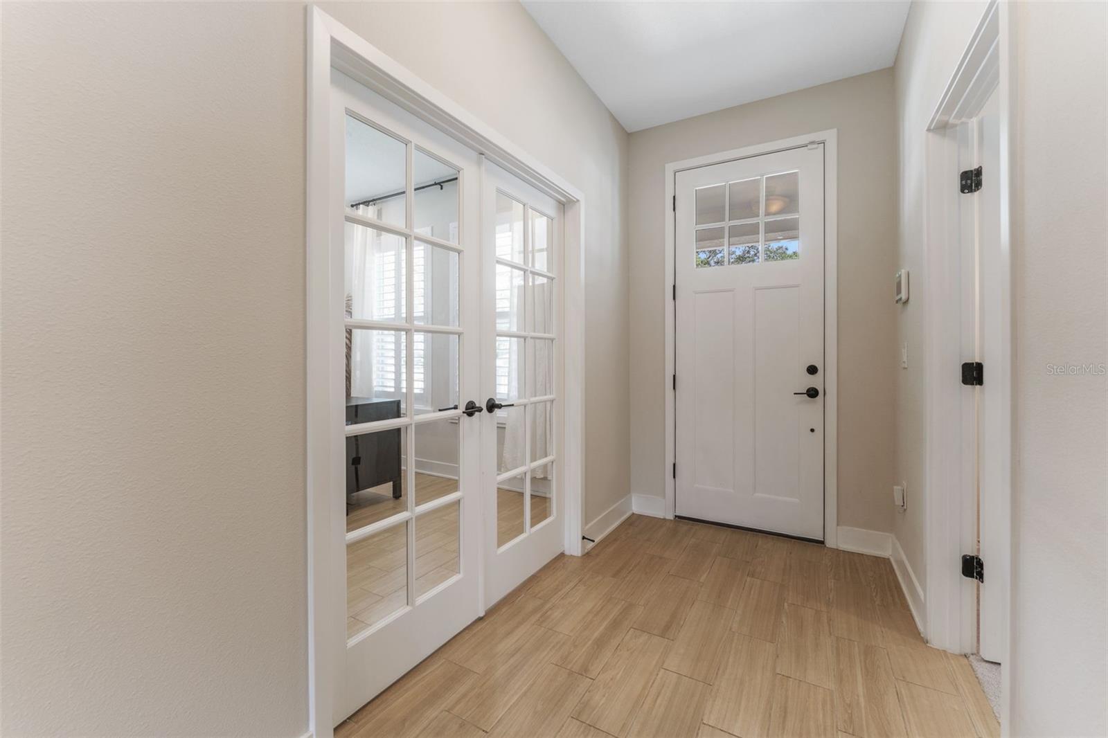 Hallway from front door.  Office on the right, bedroom on the left