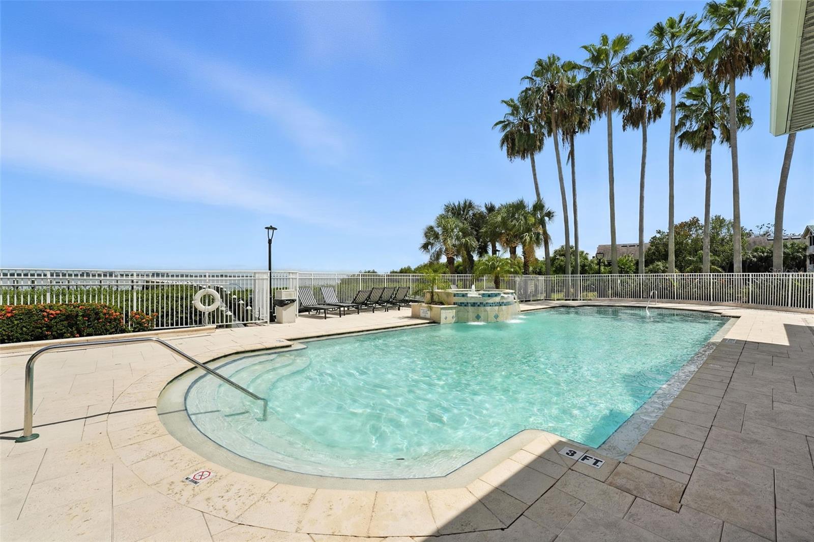 Cool off in your resort style pool, with a water view of the Bay, Dock and gorgeous landscaping