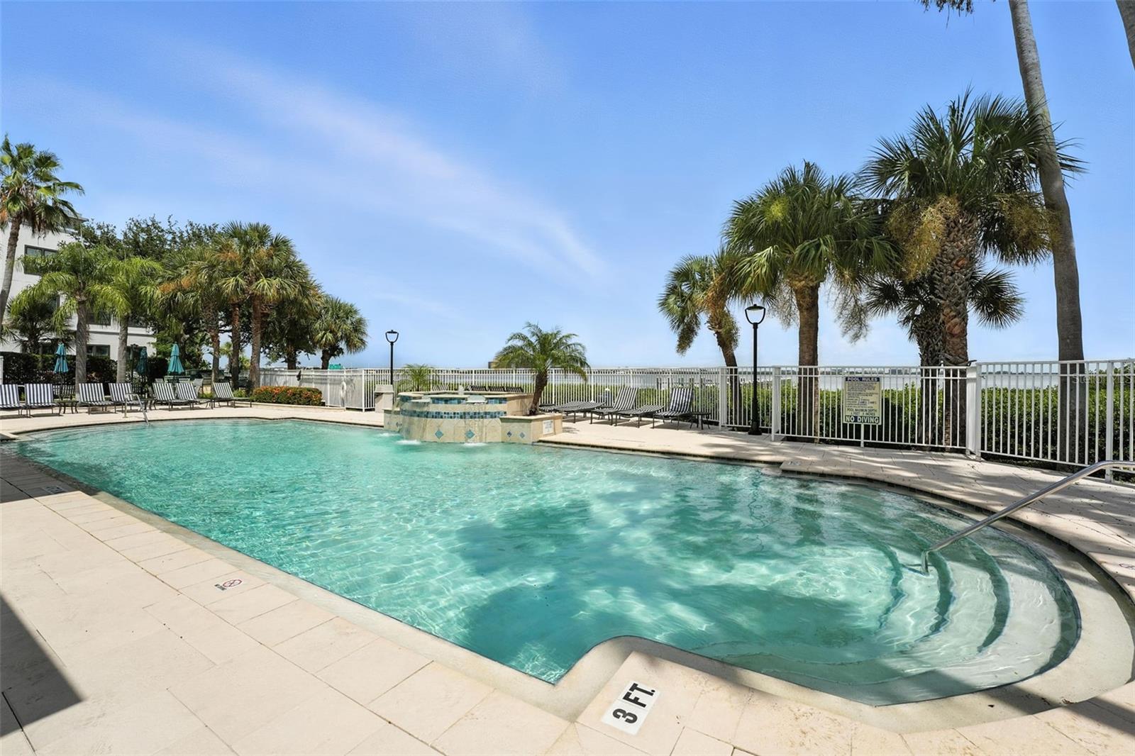 Cool off in your resort style pool, with a water view of the Bay, Dock and gorgeous landscaping