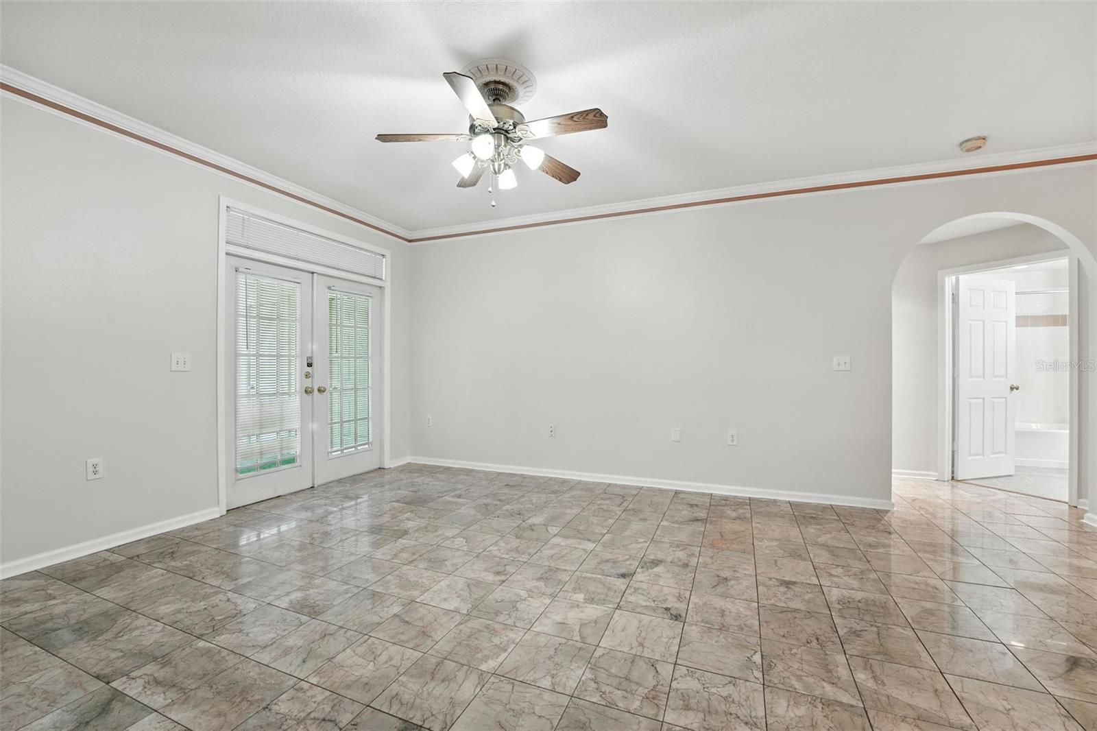 Living room, French doors lead to lanai and storage closet