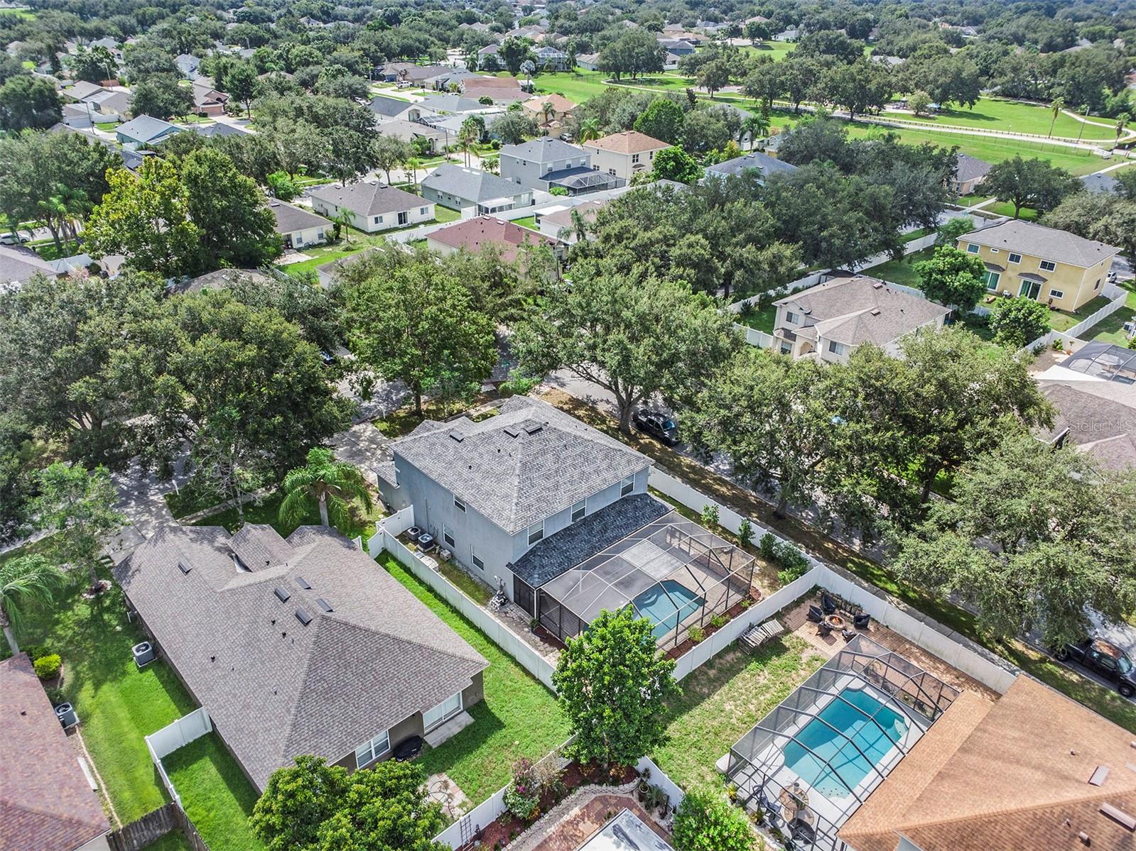 View of fenced lot and screened in ground pool