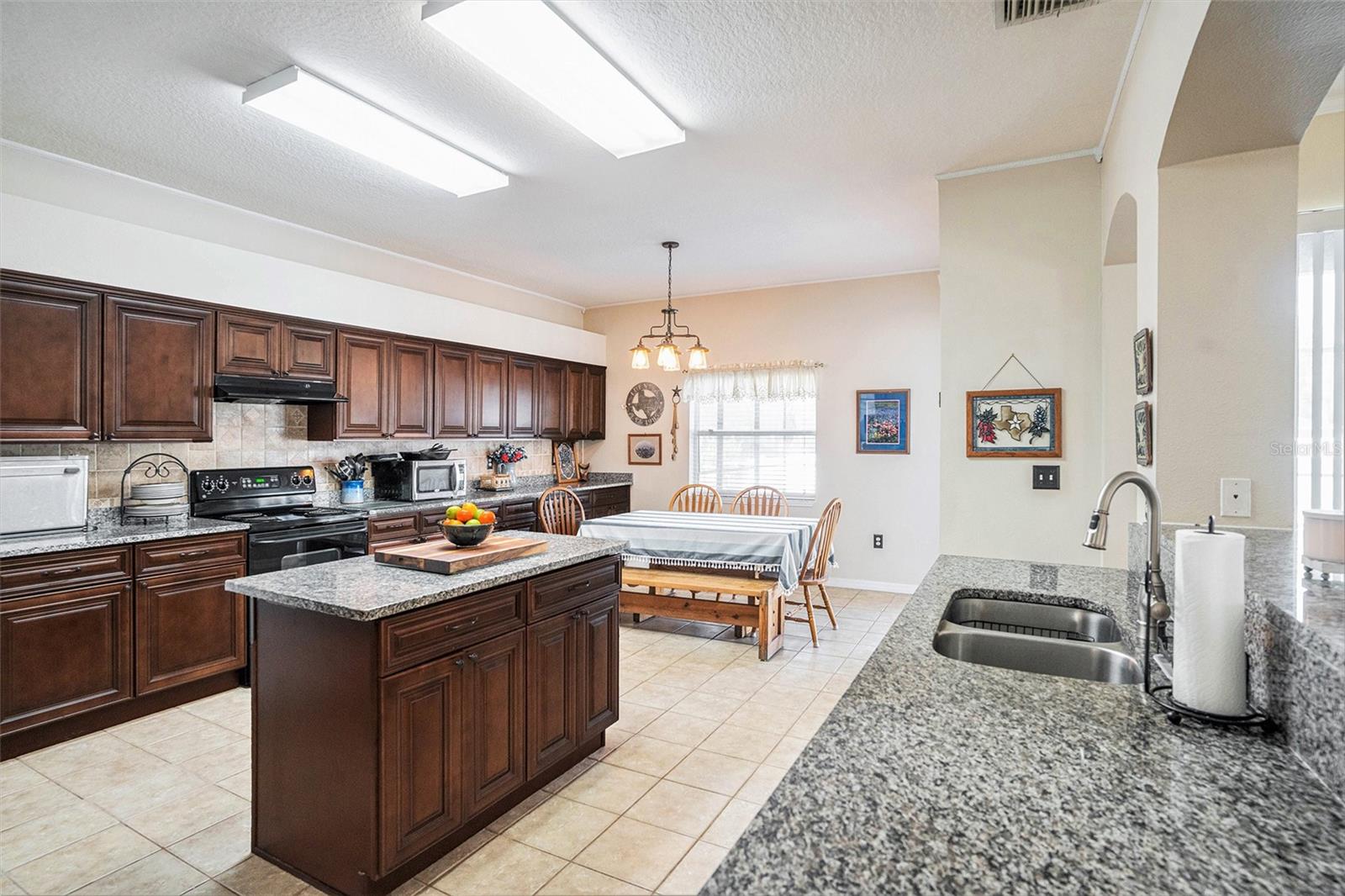 Entertainer's Dream Eat in kitchen! Island with power & pull out drawer. Tons of cabinet space. View to family room & counter space galore!
