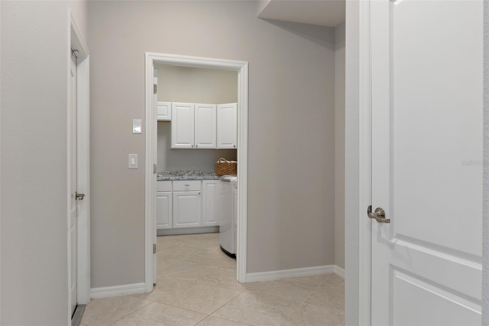 Flex space off kitchen to laundry room with an abundance of cabinets for extra storage.  Easy to build a mud room cabinet to the Right for all the shoes and sports items