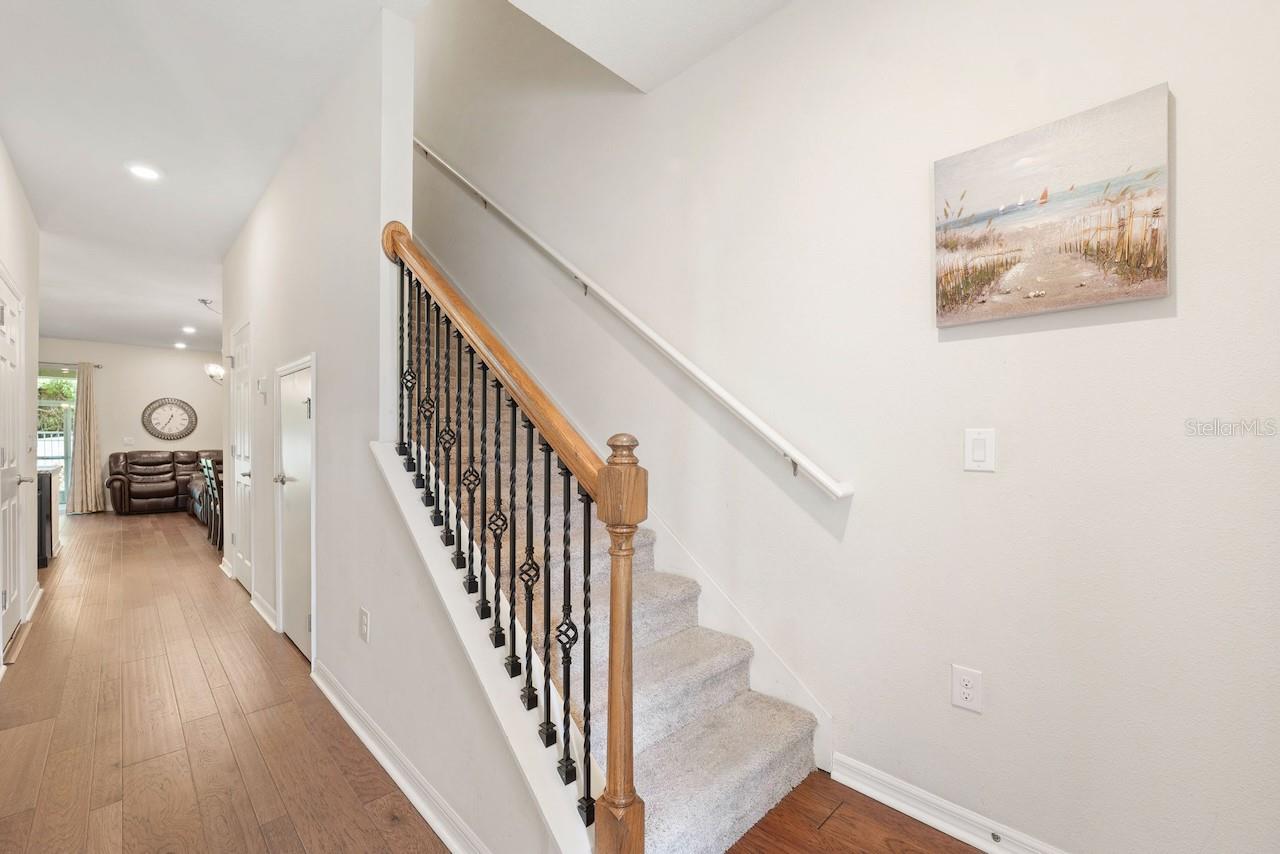 Foyer with storage closet under staircase