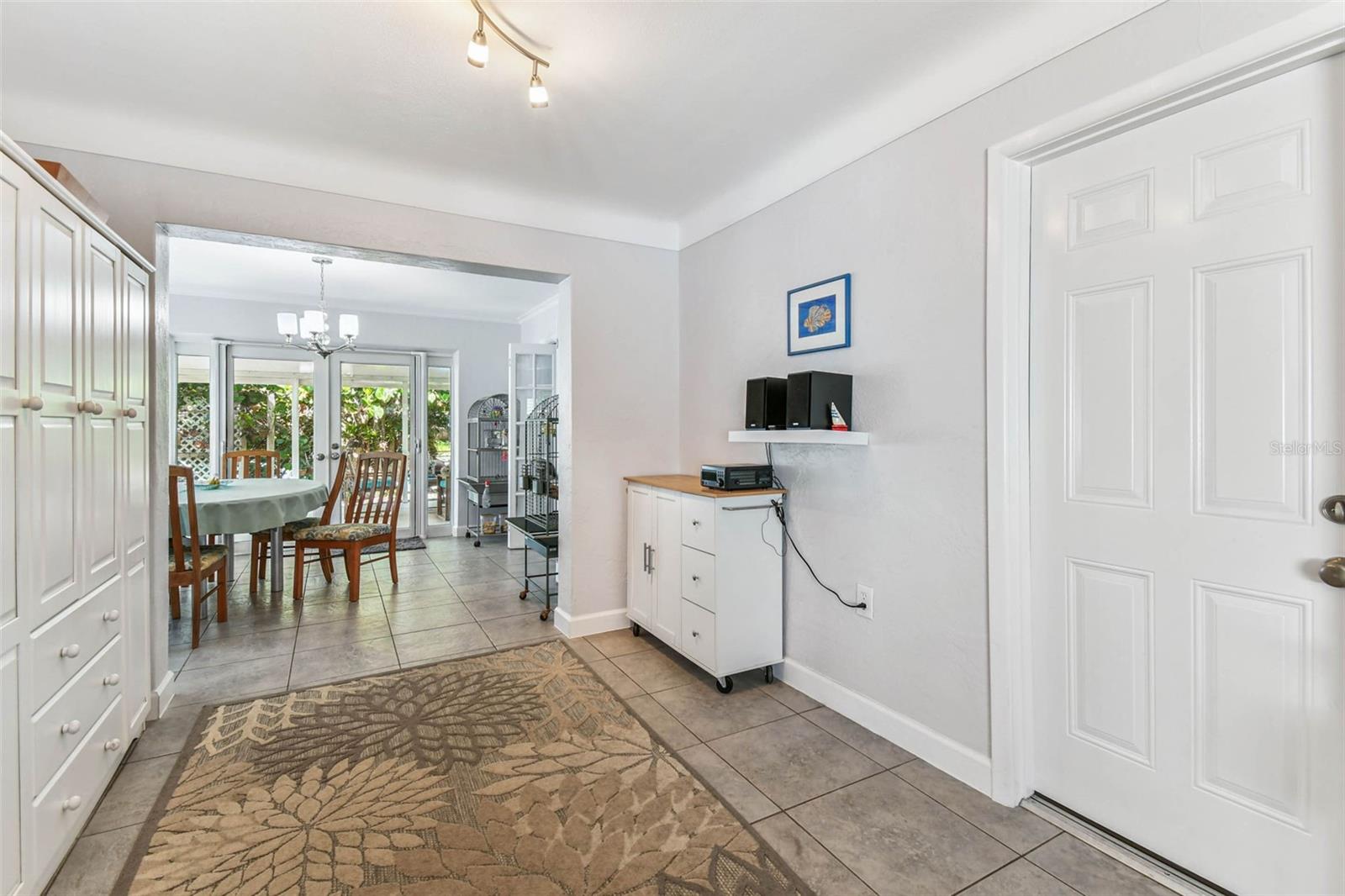 Utilized as a transition space from living room to Florida room, could easily be used as dining room.