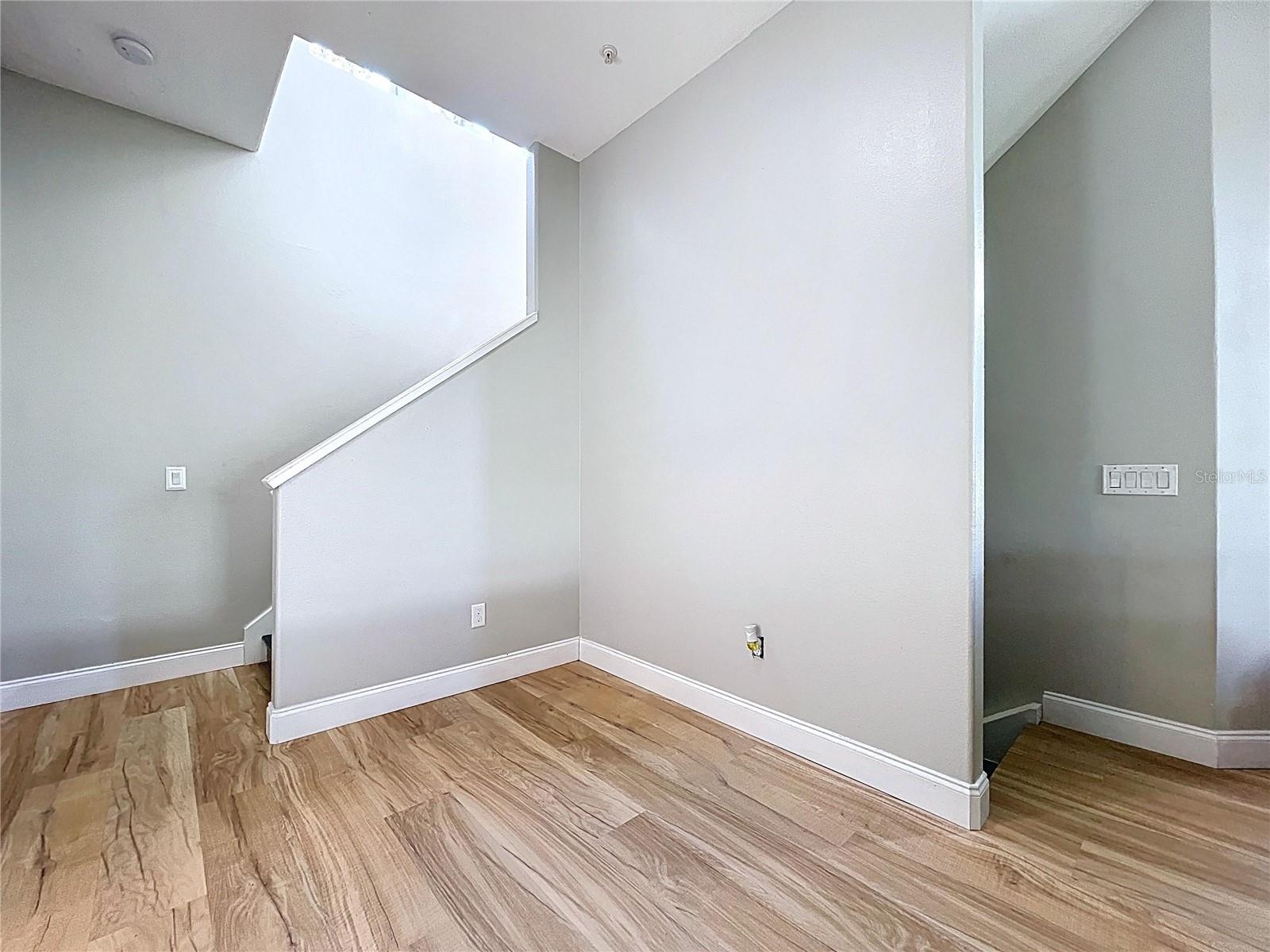 To the right, stairs coming up from entryway. To the left, stairs going to 3rd floor.