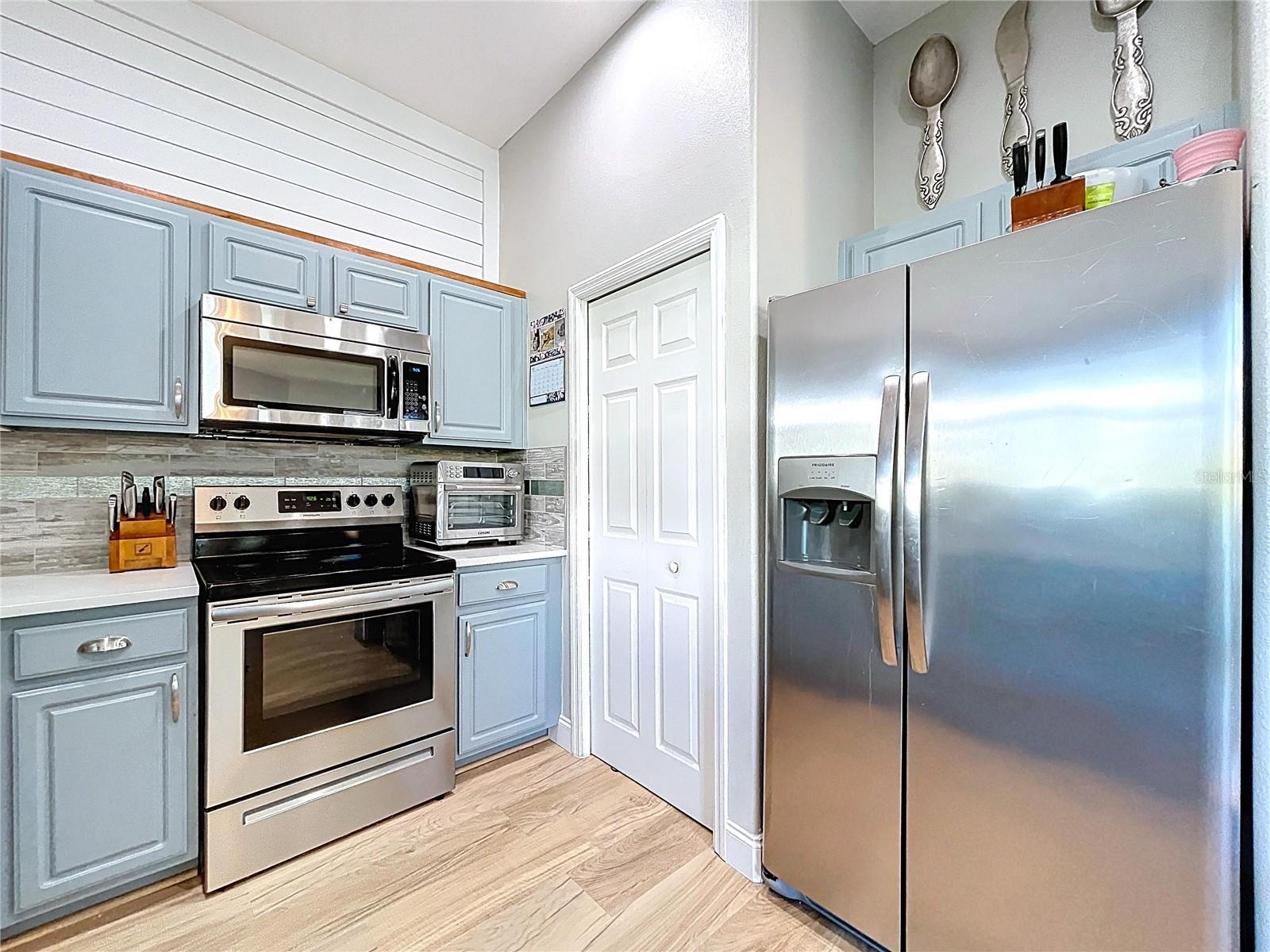 Pantry door to the left of the fridge.