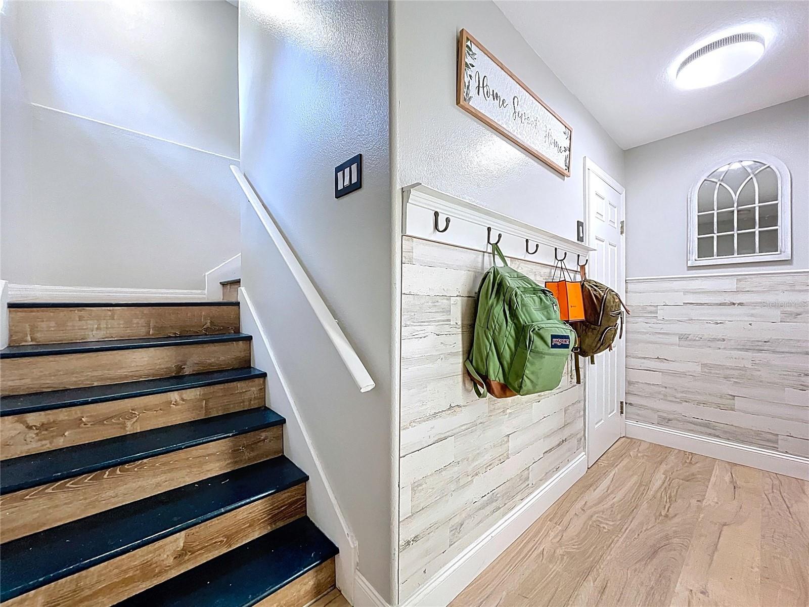 Storage closet directly across from garage entrance and stairs leading to main floor.