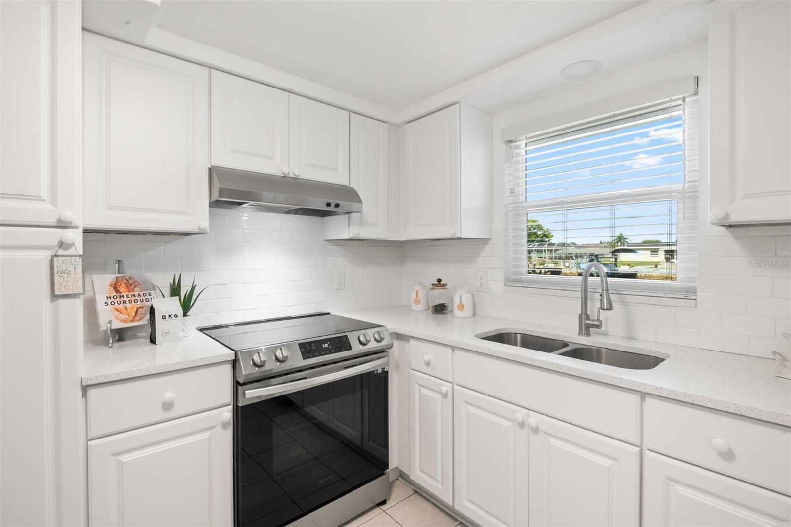 Glass top range. Pass through window to the outside when entertaining outdoors by the water.