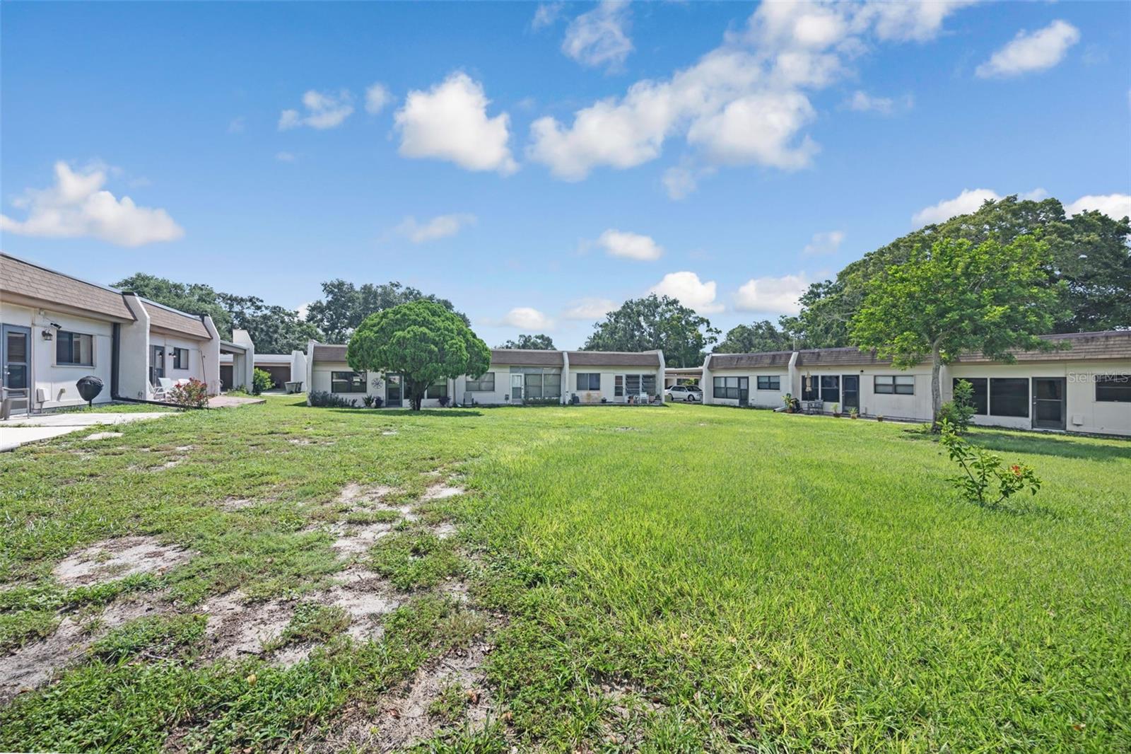Looking at the Back The Condo From The Large Yard Area