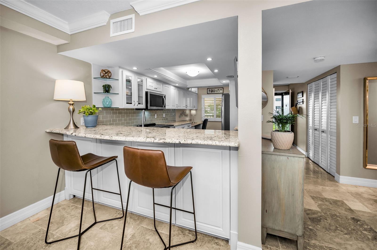 Storage cabinets on back side of breakfast bar