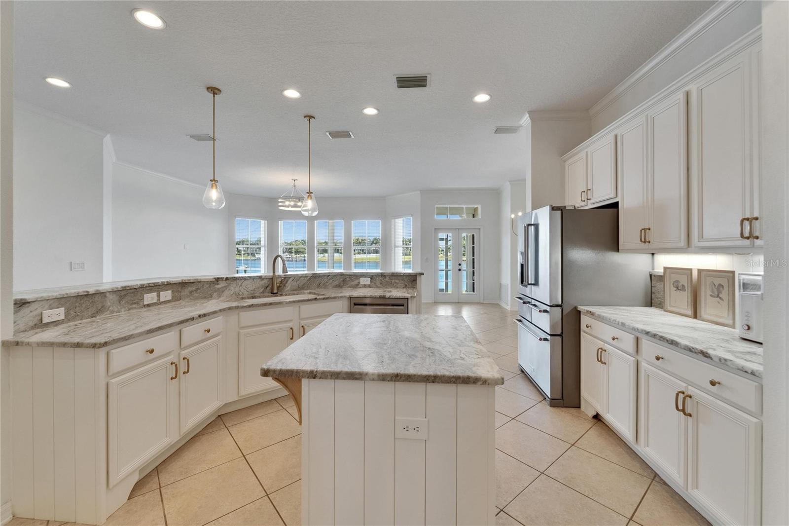 Beautiful updated kitchen overlooking family room onto the lagoon view